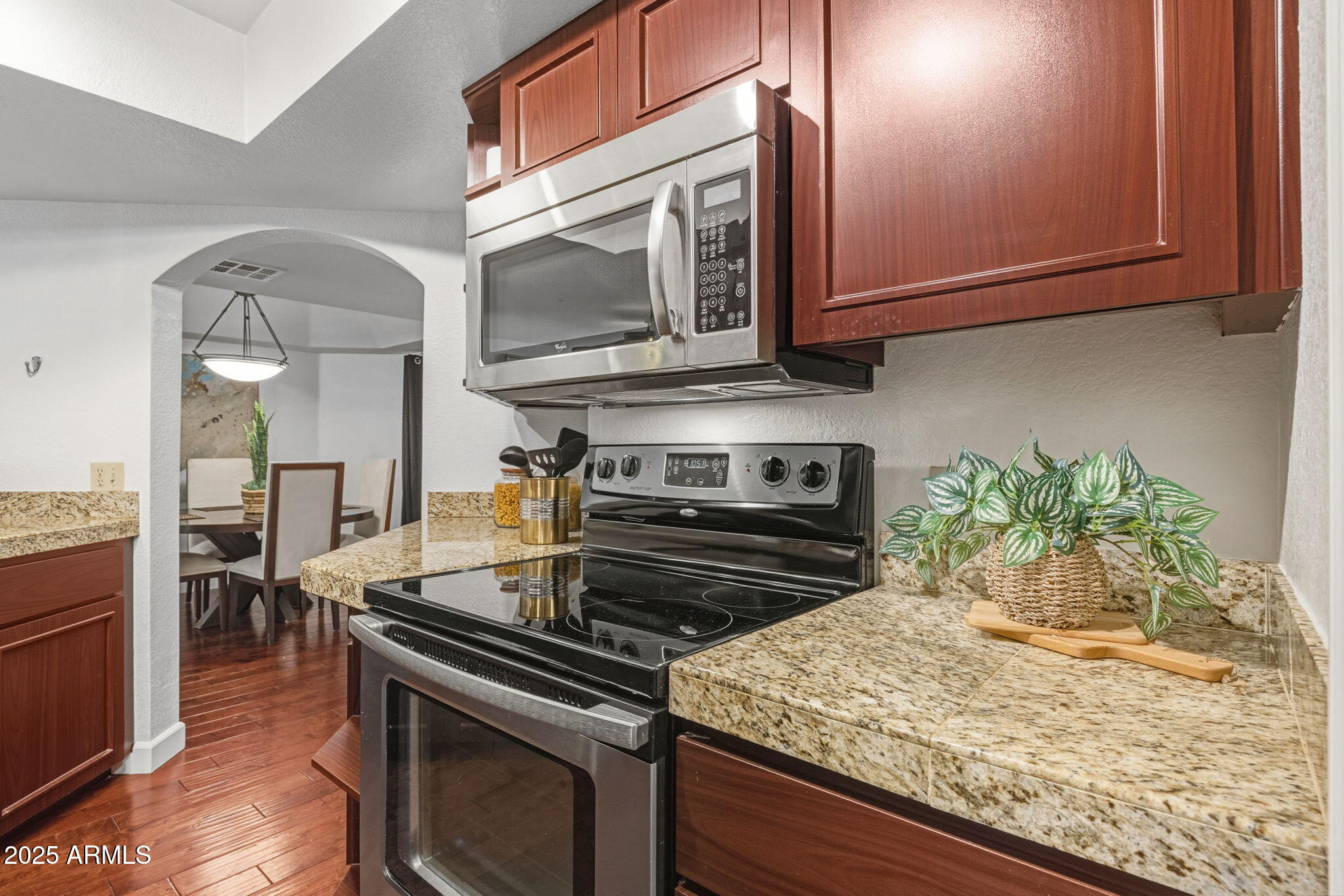 5104 North 32nd Street, Unit 344 Phoenix, AZ 85018 - Photo 12 of 30 a kitchen with stainless steel appliances granite countertop a stove and a microwave