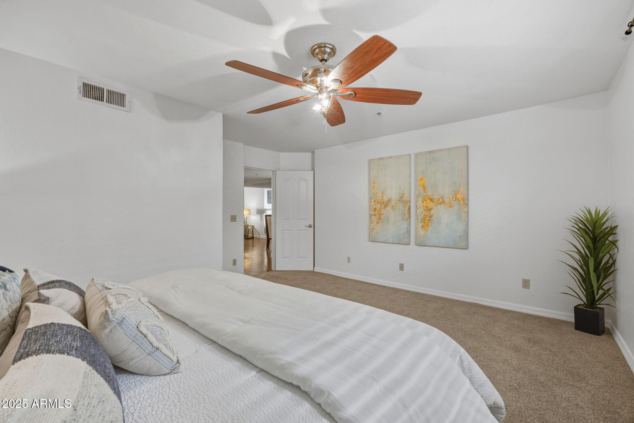 5104 North 32nd Street, Unit 344 Phoenix, AZ 85018 - Photo 17 of 30 a bedroom with a bed and a chandelier