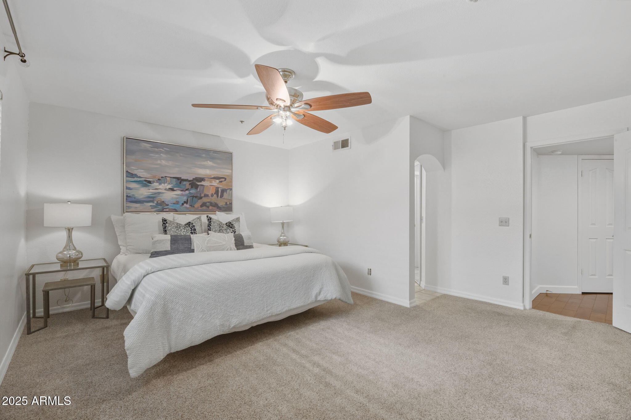 5104 North 32nd Street, Unit 344 Phoenix, AZ 85018 - Photo 18 of 30 a spacious bedroom with a bed and a chandelier