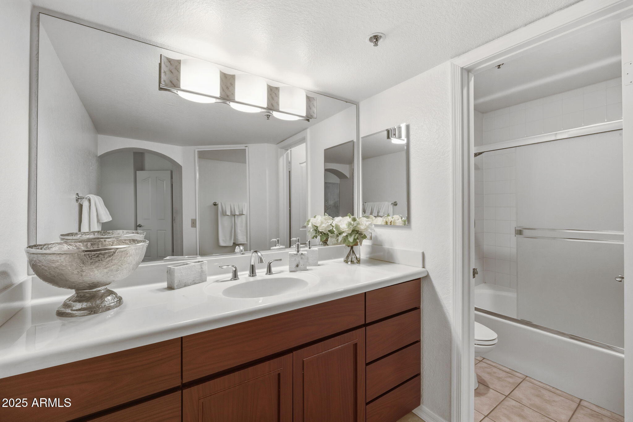 5104 North 32nd Street, Unit 344 Phoenix, AZ 85018 - Photo 19 of 30 a bathroom with a double vanity sink mirror and shower