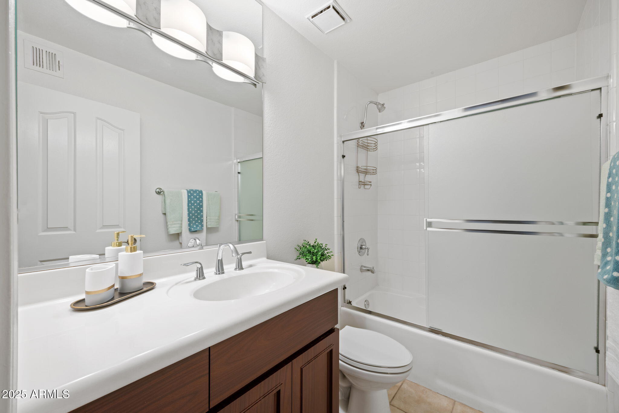 5104 North 32nd Street, Unit 344 Phoenix, AZ 85018 - Photo 24 of 30 a bathroom with a sink a toilet a mirror and shower