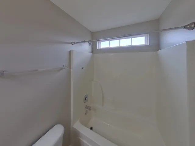 a bathroom with a bathtub and shower