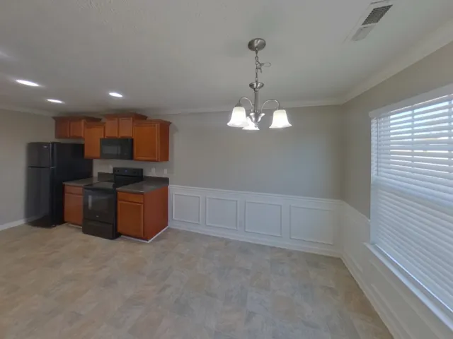 a view of a kitchen with electric appliances
