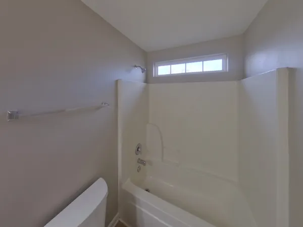 a bathroom with a shower and a toilet