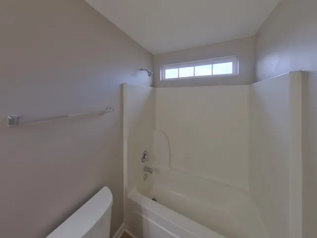 a bathroom with a shower and a toilet