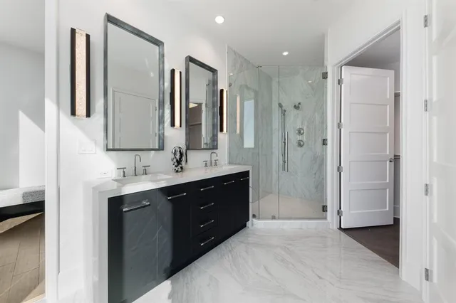 a spacious bathroom with a shower sink and mirror