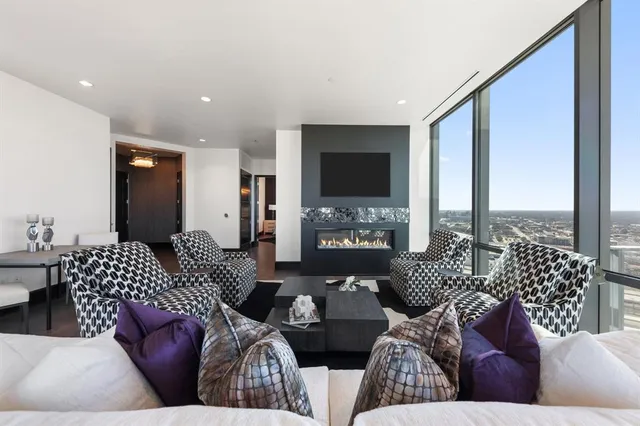 a living room with furniture fireplace and a flat screen tv
