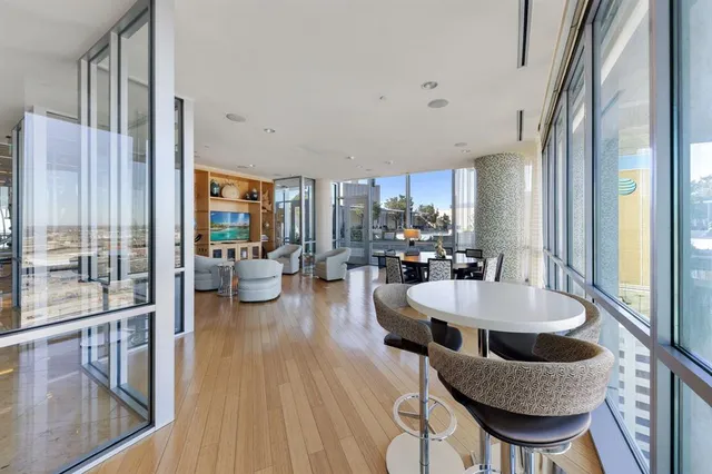 a dining room with furniture and wooden floor