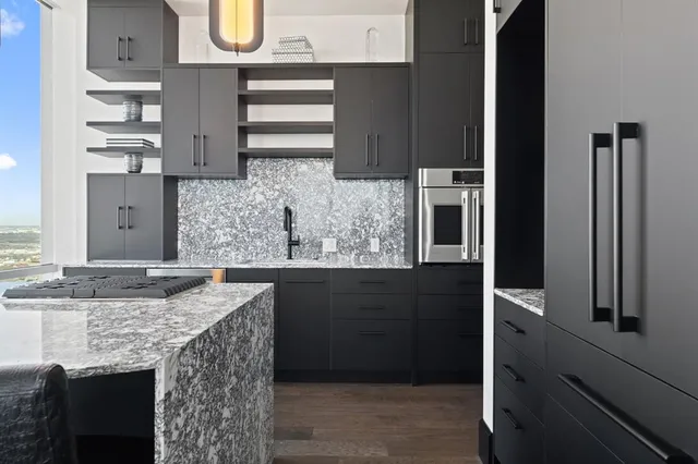 a kitchen with stainless steel appliances granite countertop a refrigerator and a sink