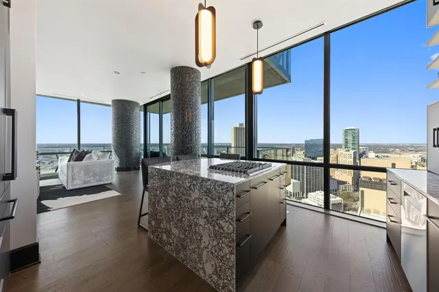 a open kitchen with stainless steel appliances kitchen island granite countertop a sink and cabinets
