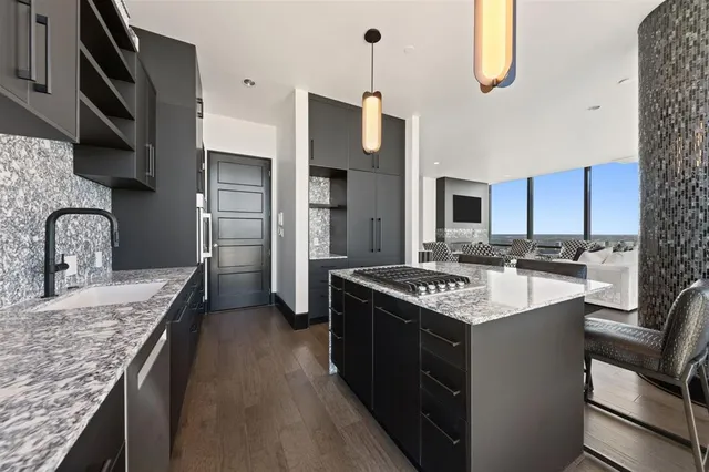 a kitchen with stainless steel appliances granite countertop a sink stove and refrigerator