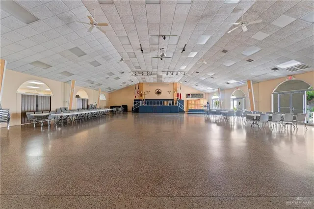 a view of a room with lots of dining space and wooden floor