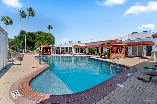 swimming pool view with a seating space