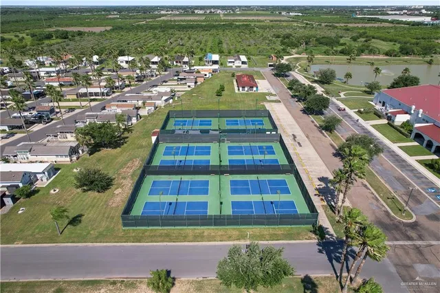 an aerial view of residential houses with outdoor space and river