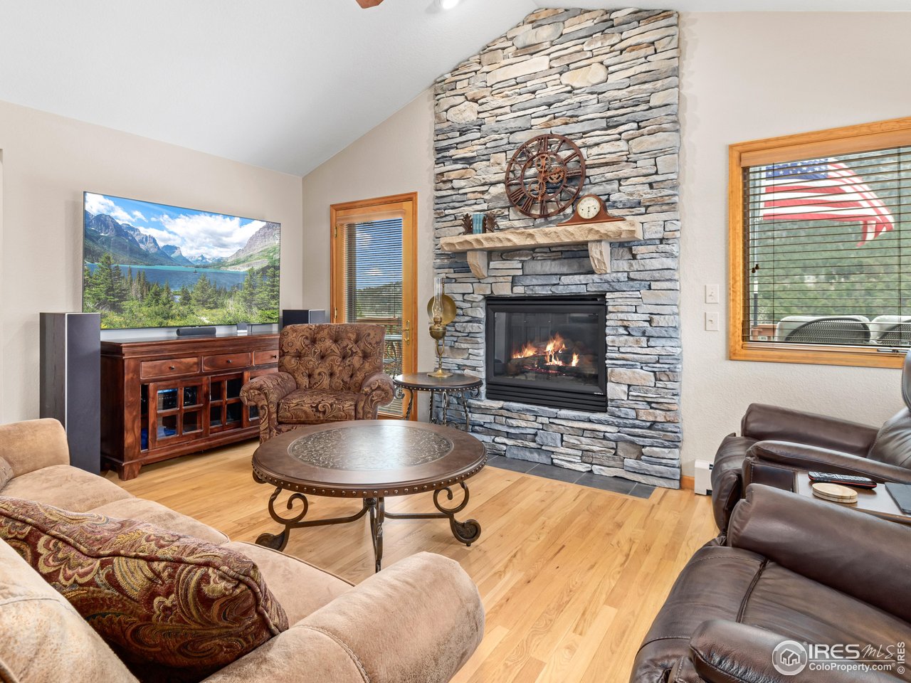 658 Cedar Ridge Circle Estes Park, CO 80517 - Photo 7 of 39 Stone fireplace and hardwood flooring