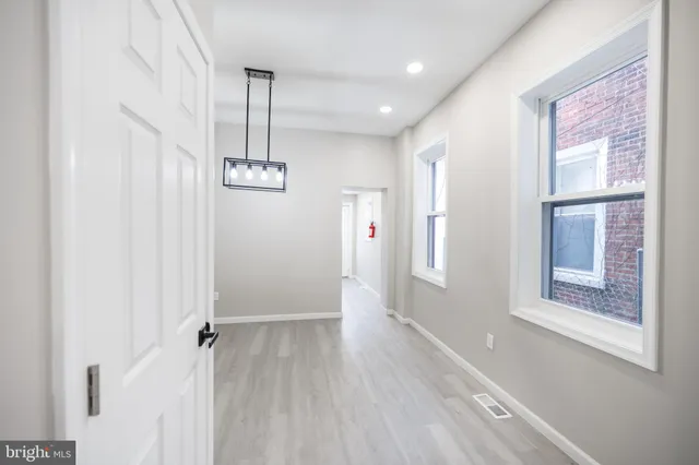 a view of an entryway with wooden floor