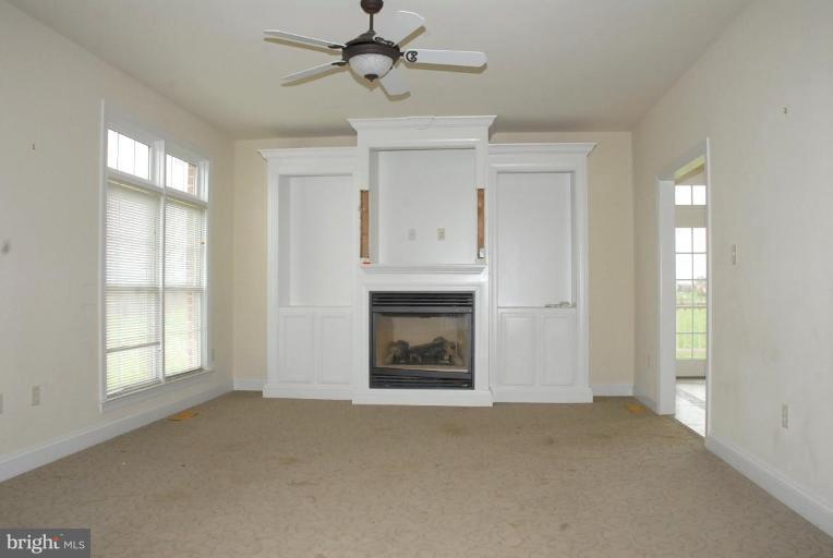 13678 Clear Spring Road Clear Spring, MD 21722 - Photo 17 of 28 a view of an empty room with a fireplace and a window