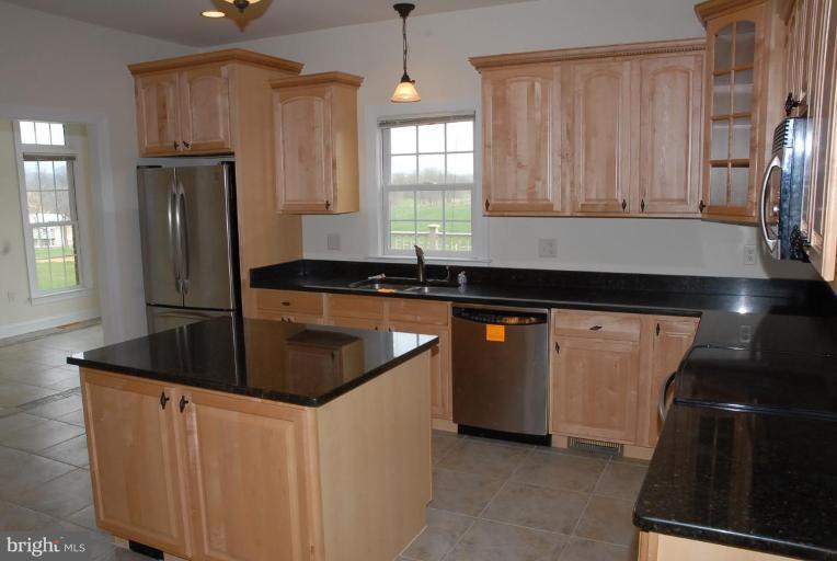13678 Clear Spring Road Clear Spring, MD 21722 - Photo 28 of 28 a kitchen with granite countertop a sink and a refrigerator