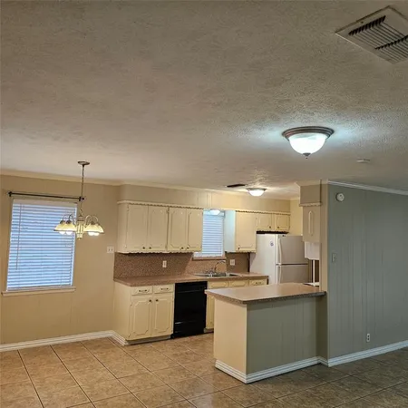 a large kitchen with kitchen island a sink stainless steel appliances and cabinets