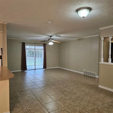 en empty room with windows and entrance