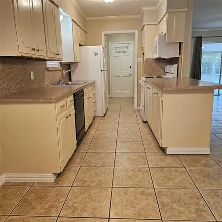 a kitchen with stainless steel appliances granite countertop a refrigerator and a stove