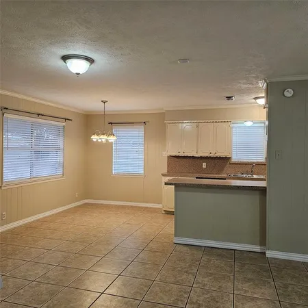 a kitchen with granite countertop a sink and a stove
