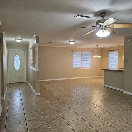 a view of a livingroom with a ceiling fan and window