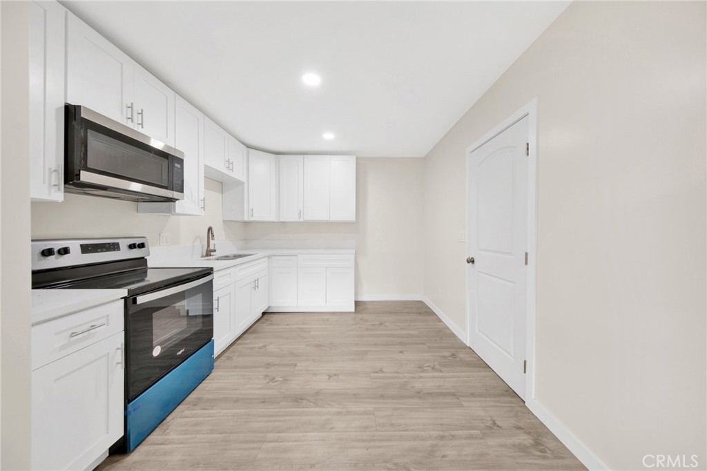 12540 Dexter Park Road Sylmar, CA 91342 - Photo 11 of 31 a large kitchen with stainless steel appliances granite countertop a stove and a sink