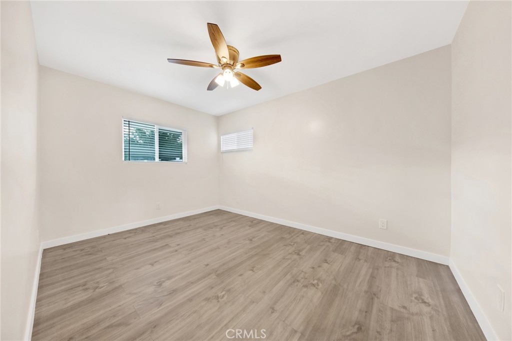 12540 Dexter Park Road Sylmar, CA 91342 - Photo 17 of 31 an empty room with wooden floor fan and windows