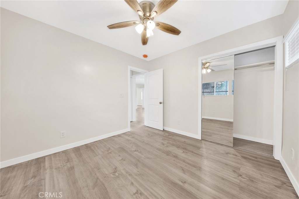 12540 Dexter Park Road Sylmar, CA 91342 - Photo 22 of 31 an empty room with wooden floor ceiling fan and windows