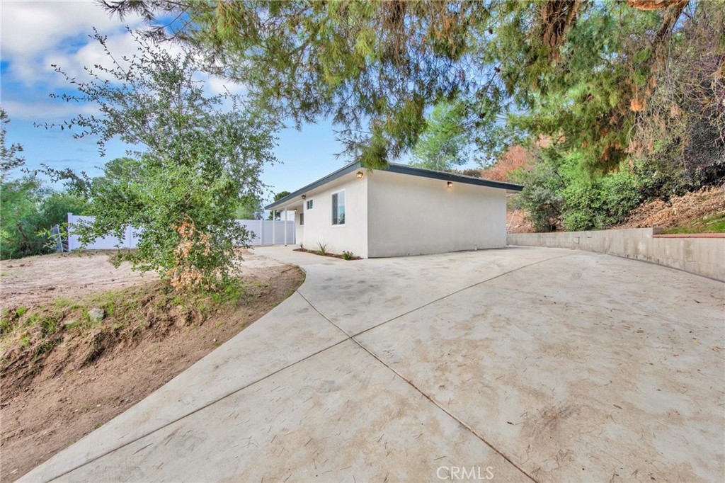 12540 Dexter Park Road Sylmar, CA 91342 - Photo 4 of 31 a white house that has a tree in front of it
