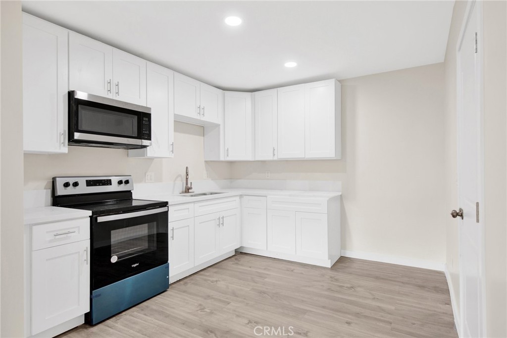 12540 Dexter Park Road Sylmar, CA 91342 - Photo 10 of 31 a kitchen with stainless steel appliances granite countertop a stove and a sink