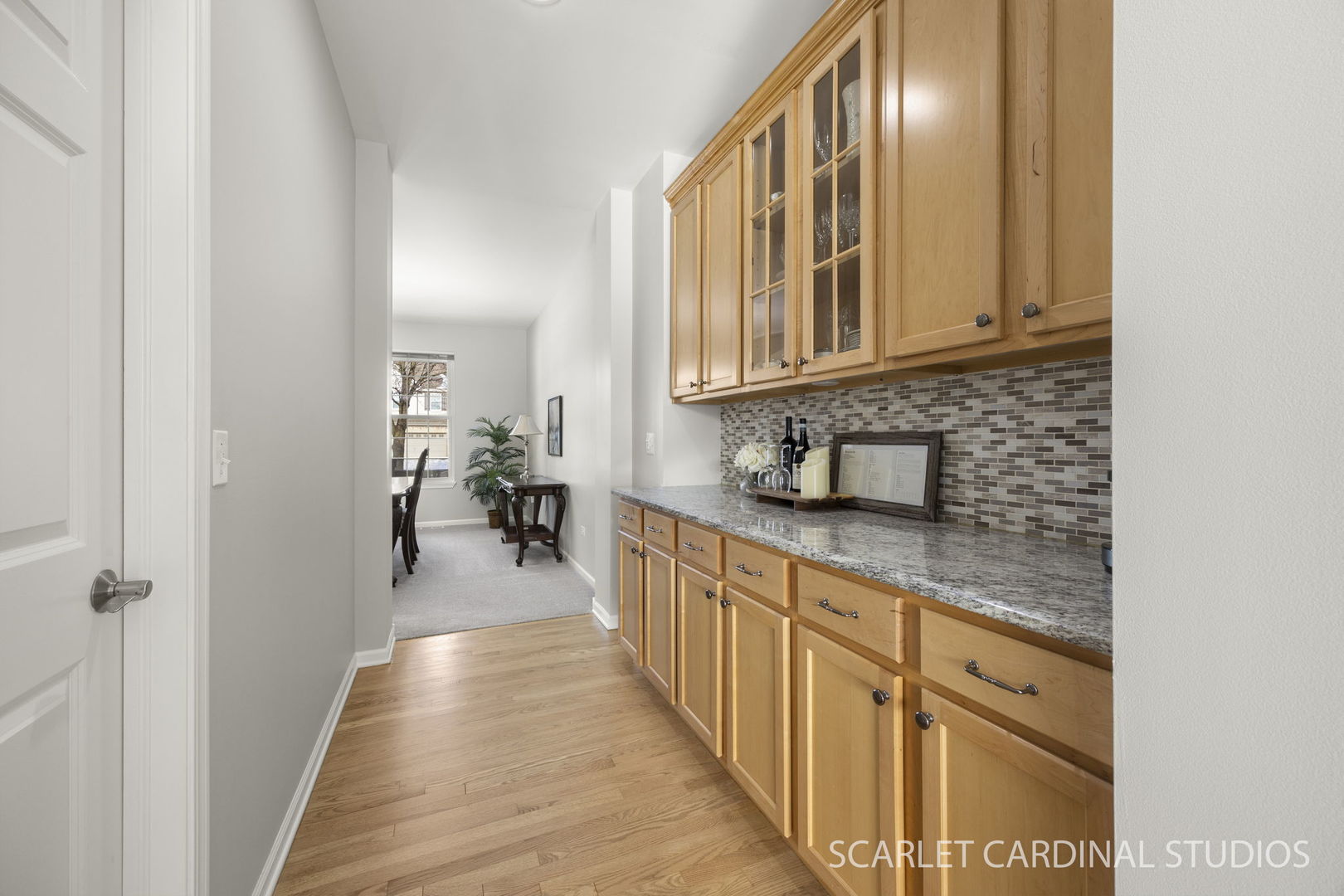 26115 Mapleview Drive Plainfield, IL 60585 - Photo 11 of 36 a hallway with granite countertop a sink a window and a white appliances