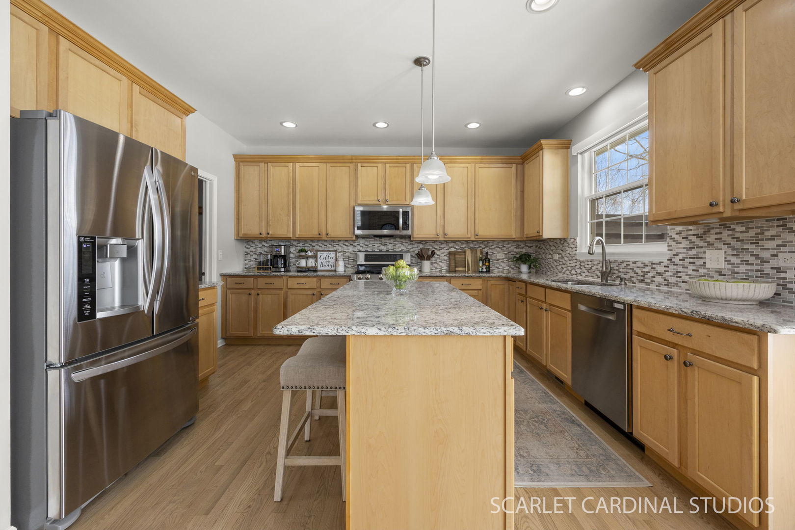 26115 Mapleview Drive Plainfield, IL 60585 - Photo 3 of 36 a kitchen with stainless steel appliances granite countertop a refrigerator a sink a stove a microwave and island