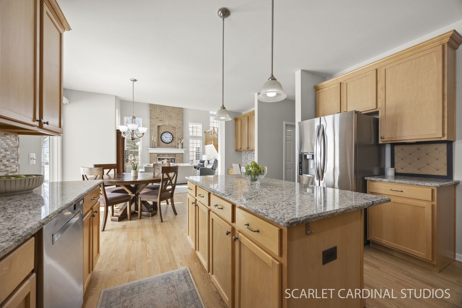 26115 Mapleview Drive Plainfield, IL 60585 - Photo 5 of 36 a kitchen with stainless steel appliances granite countertop table chairs and a refrigerator
