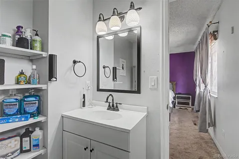 a bathroom with a sink a vanity and a mirror
