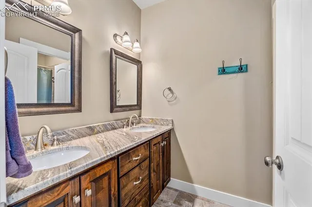 a bathroom with double sink and a mirror