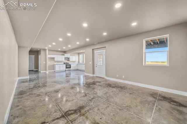 a large white kitchen with cabinets