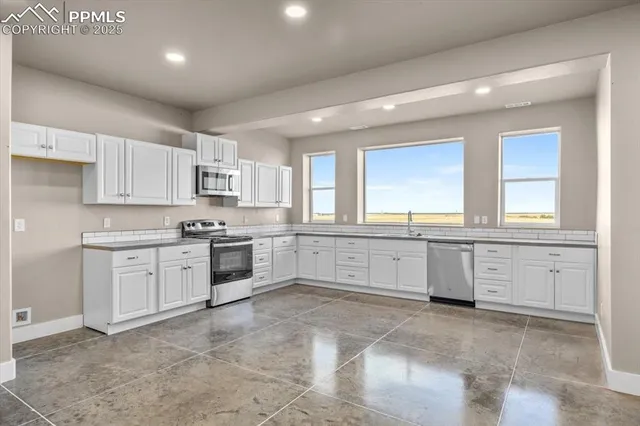 a view of a kitchen with a sink and a window