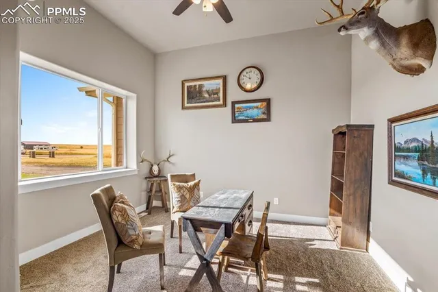 a view of a dining room with furniture and a large window