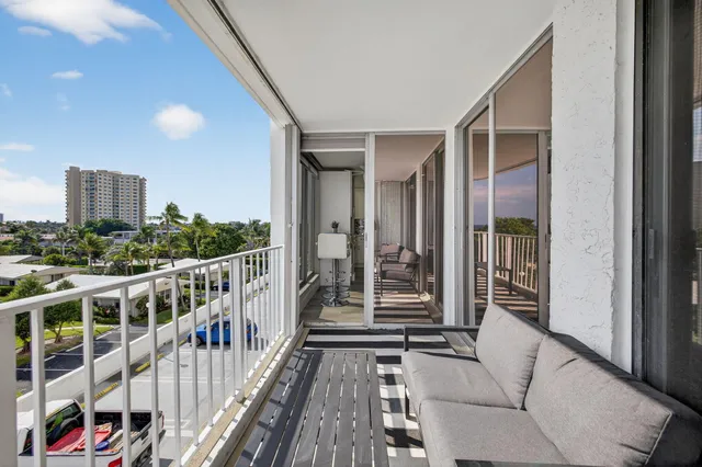 a bedroom with a large bed and a flat tv screen on dresser
