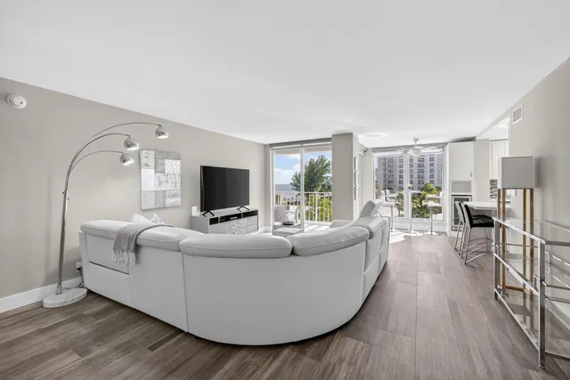 a living room with furniture wooden floor and a flat screen tv