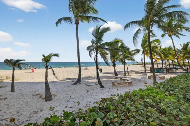a living room with furniture kitchen view and a refrigerator
