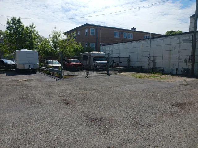 a backyard of a house with barbeque oven and outdoor seating