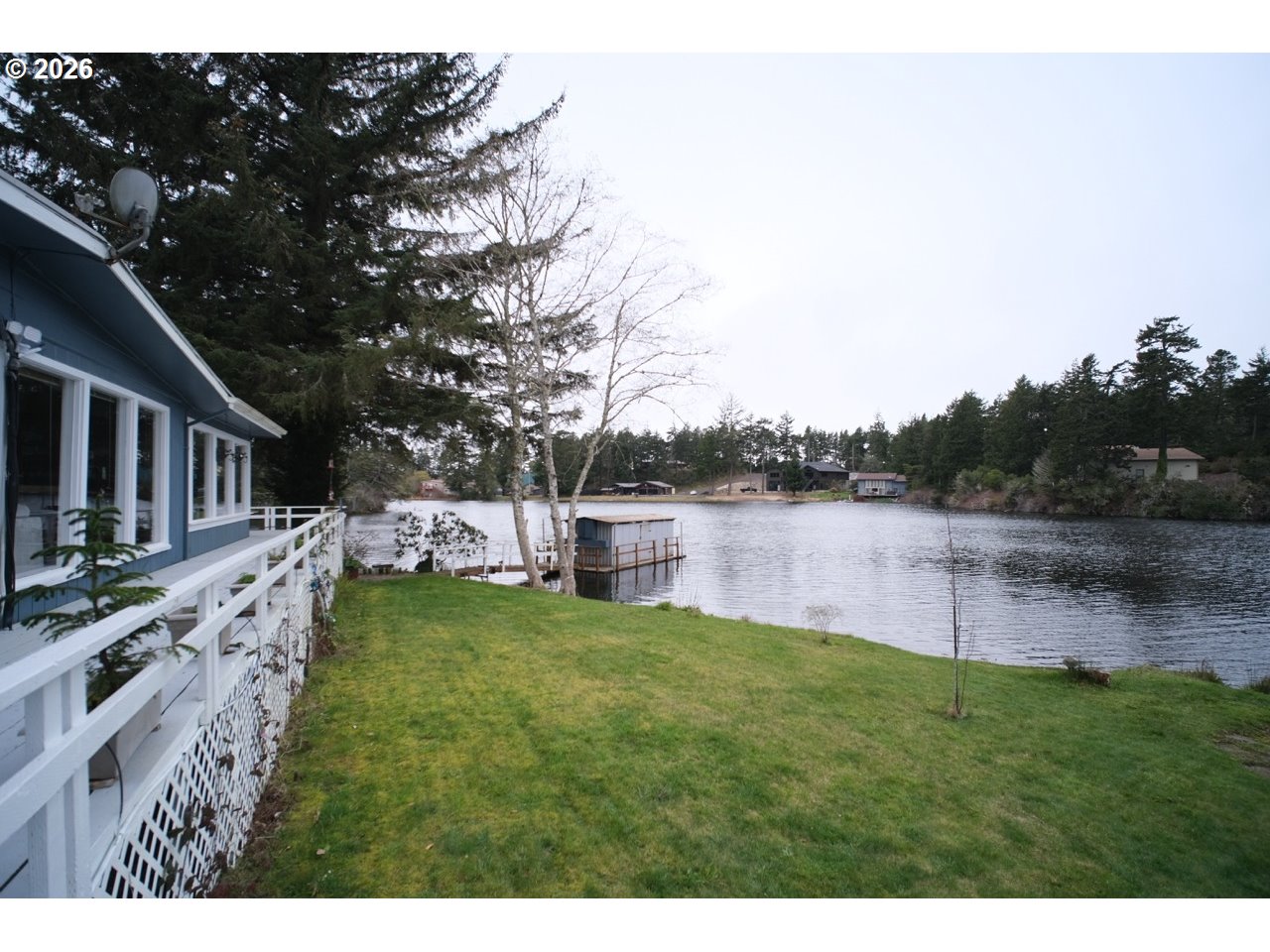 70214 Lakewood Road North Bend, OR 97459 - Photo 33 of 39 a view of a lake with houses in the background