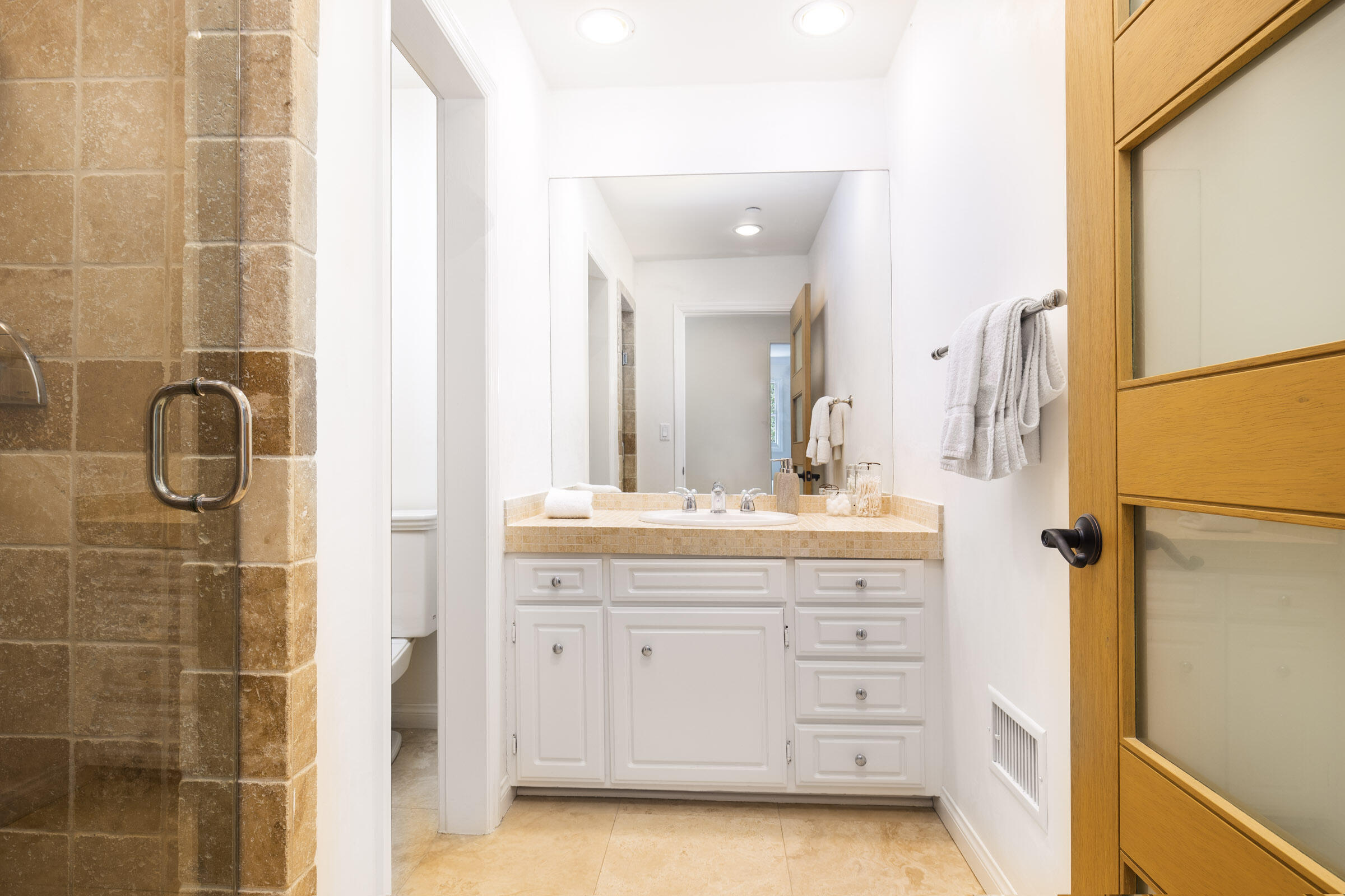 612 Cowles Road Montecito, CA 93108 - Photo 15 of 26 a bathroom with a granite countertop sink a mirror and a shower