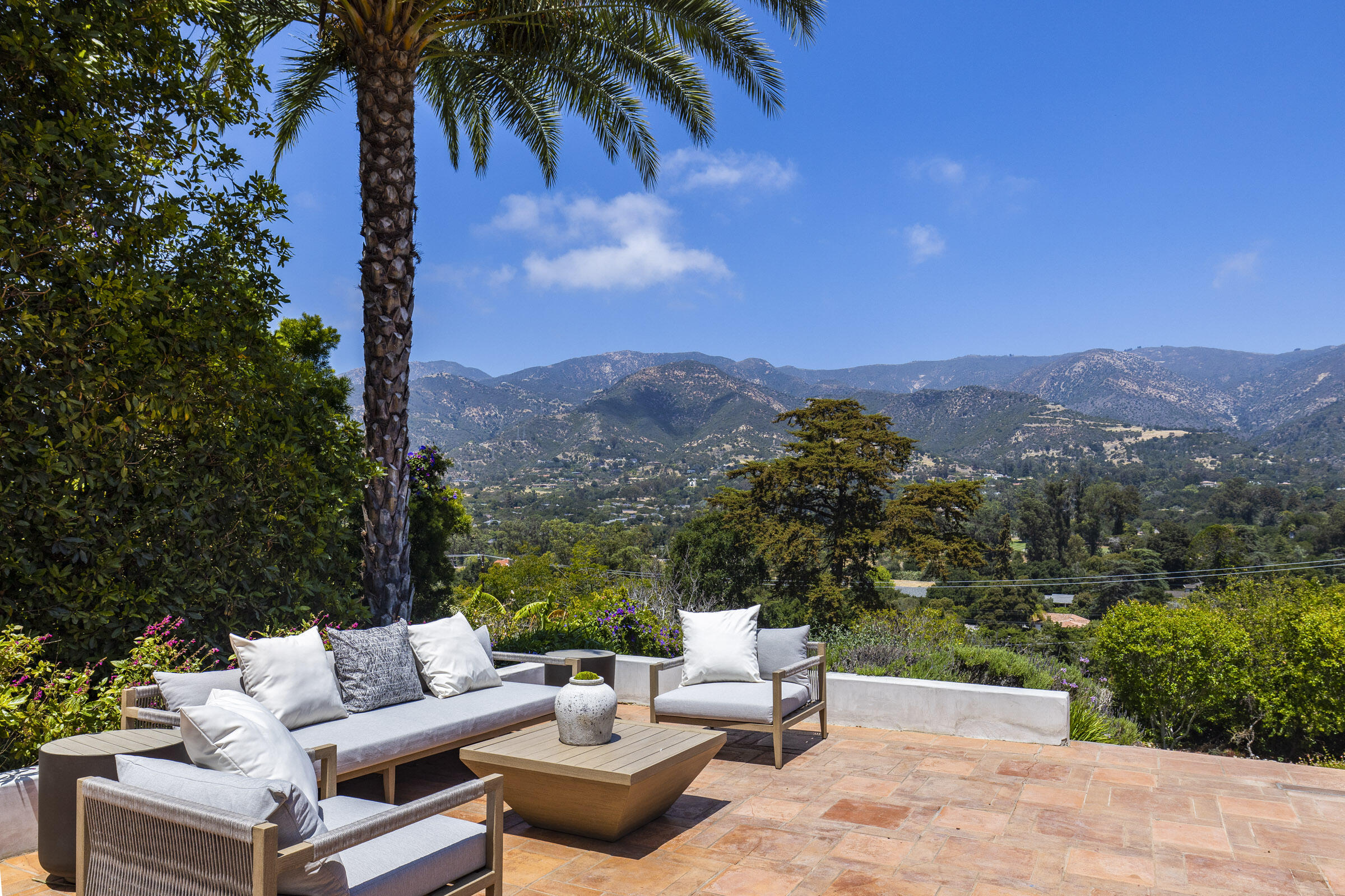 612 Cowles Road Montecito, CA 93108 - Photo 19 of 26 a view of a patio with couches and table and chairs under an umbrella