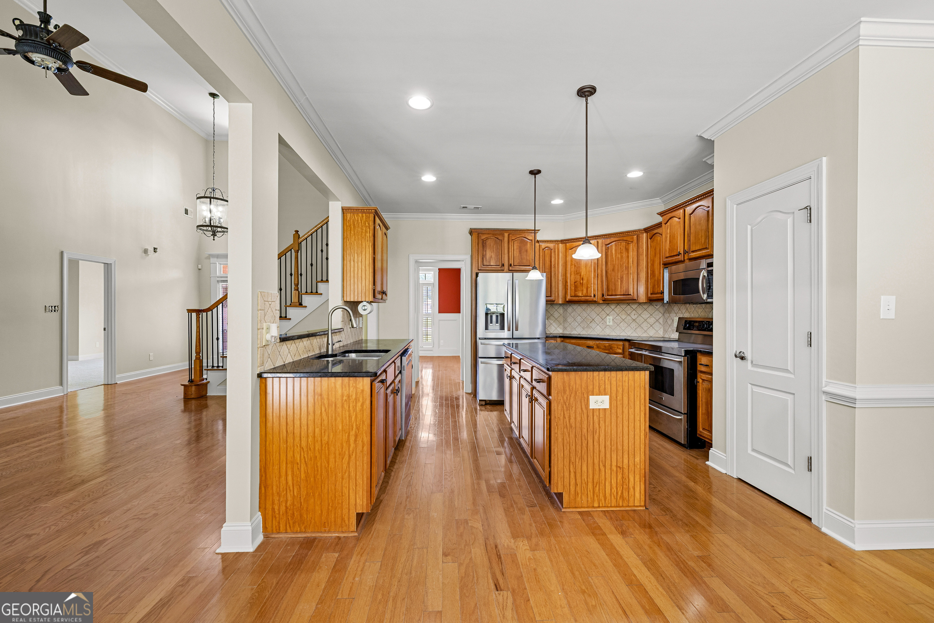 120 Shankhill Ridge Tyrone, GA 30290 - Photo 20 of 53 a kitchen with stainless steel appliances granite countertop a refrigerator a stove top oven a sink dishwasher and a refrigerator with wooden floor
