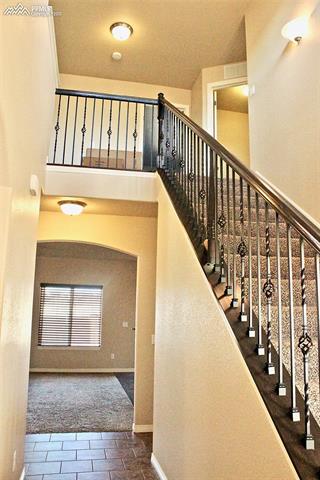 6740 Red Cardinal Loop Colorado Springs, CO 80908 - Photo 2 of 21 entry way, stairs, vaulted ceilings
