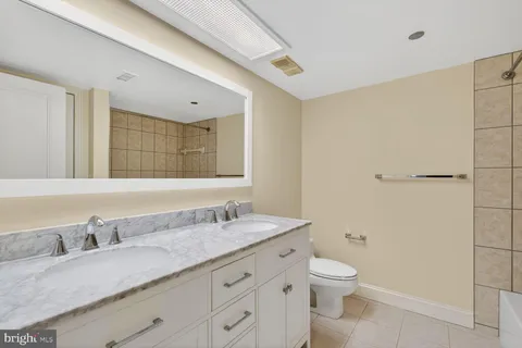 a view of a room with wooden floor and ceiling fan